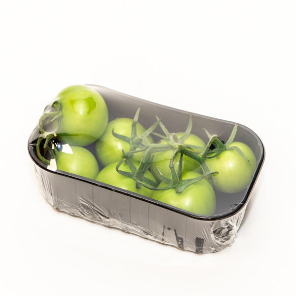 Green tomatoes on the vine in a 0.5 kg pack, fresh Holland vegetable product, with vibrant green color and ripe appearance.