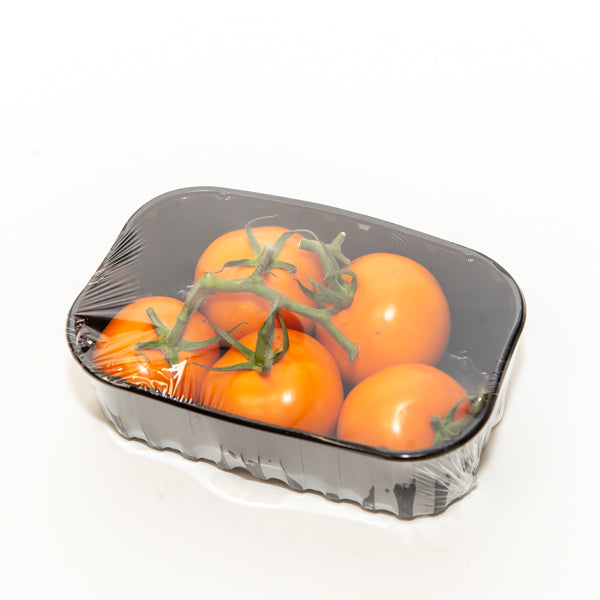 Orange tomatoes on the vine from Holland in a 0.5 kg vegetable pack, fresh and ripe with vibrant color.
