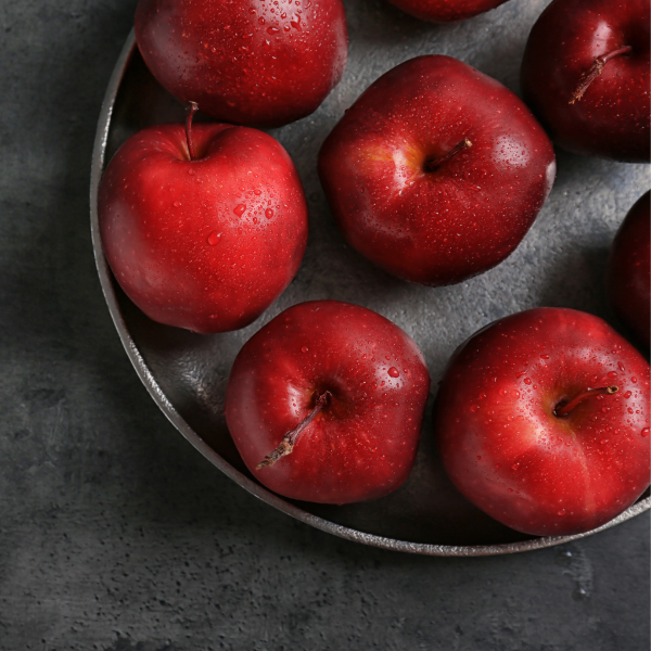Fresh red Delicious apples from Sharbatly in a 4 kg carton, showcasing vibrant, ripe apples with smooth skin and bright color.